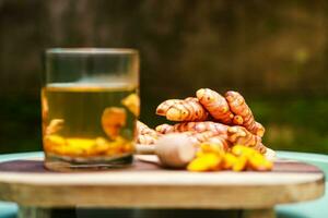 herbal drink from soaking pieces of turmeric with warm water and honey photo