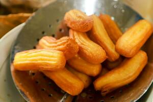 churros, traditional Spanish food served with chocolate and warm milk on the table photo