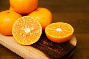 few pieces of orange fruit on a wooden table photo