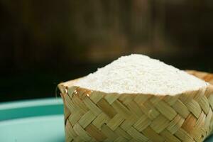 white rice seeds on a bamboo bowl photo