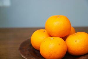 few pieces of orange fruit on a wooden table photo