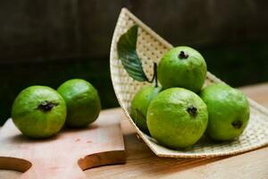 Some fresh guava on the bamboo tray photo