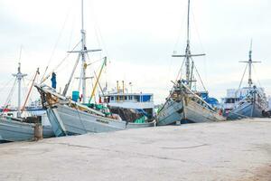 The hustle and bustle in the morning at traditional ports when loading and unloading goods and passengers photo