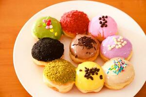 Mini donuts with various flavors and variants served on a plate photo
