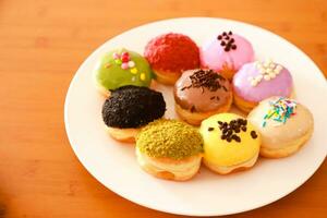 Mini donuts with various flavors and variants served on a plate photo