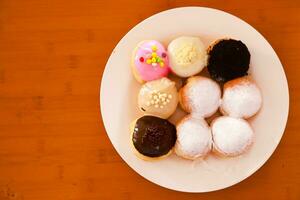 Mini donuts with various flavors and variants served on a plate photo