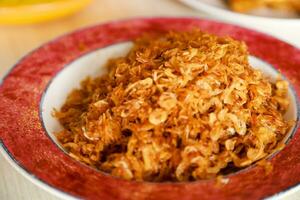 fried ebi teri medan or dried baby prawns served as a side dish on a plate photo