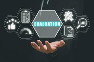 Evaluation concept, Business person hand holding evaluation icon on virtual screen. photo