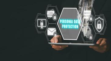 Personal data protection concept, Businesswoman hand holding tablet with personal data protection icon on virtual screen. photo