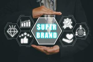 Super brand concept, Business person hand holding super brand icon on virtual screen. photo