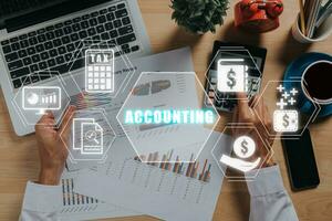 Accounting concept, Businessman using calculator and analyzing financial data on office desk with accounting icon on virtual screen. photo