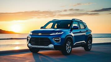 A brand-less generic SUV car on the beach at sunset photo