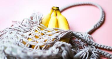 Banner Bananas in a string bag. Zero waste. Caring for nature. Refusal of plastic photo