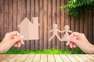 Hands holding family papers on wooden fence background. photo