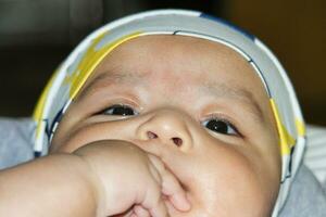 Close Up Shot of Cute Asian Pakistani 4 Months Old Baby Boy, Who is Enjoying at Home Garden at Luton City of England UK. Image Was Captured on July 23rd, 2023 photo