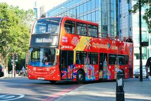 Gorgeous Low Angle view of Bus Service and British Traffic at London Bridge Which is Most Famous and Historical Bridge over River Thames at Central London City of England UK. June 4th, 2023 photo