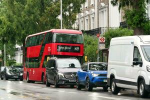 Gorgeous Low Angle view of Bus Service and British Traffic at Central London City of England UK. Image Captured on August 2nd, 2023 During Cloudy and Rainy Day. photo