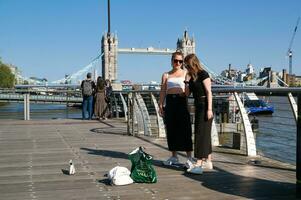 Most Beautiful Image of International Community Tourist People are Visiting Tower Bridge and River Thames at Central London Capital City of England Great Britain UK on Sunny Day of June 4th, 2023 photo