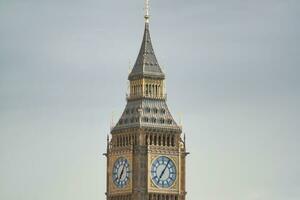 Beautiful Low Angle View of Historical Big Ben Clock Tower from river Thames and London Eye, Westminster Central London, England Great Britain, UK. Image Captured During Cloudy Day of August 2nd, 2023 photo