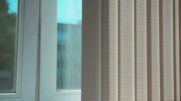 Vertical blinds protect from the sun on a hot day. video