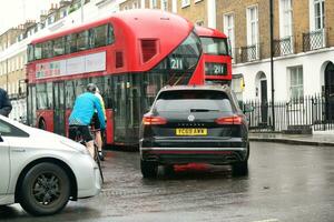 Gorgeous Low Angle view of Bus Service and British Traffic at Central London City of England UK. Image Captured on August 2nd, 2023 During Cloudy and Rainy Day. photo