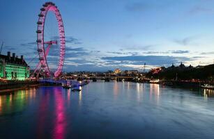 Most Beautiful Footage of Illuminated London eye from River Thames Westminster, Big Ben clock Tower at After Sunset Night. England Great Britain,  Footage Was Captured on Aug 02nd, 2023 After Sunset. photo