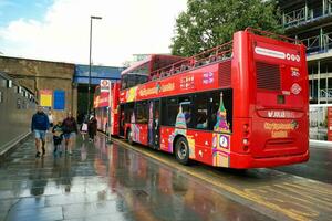 Gorgeous Low Angle view of Bus Service and British Traffic at Central London City of England UK. Image Captured on August 2nd, 2023 During Cloudy and Rainy Day. photo