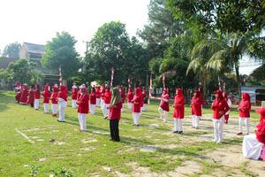 Bogor-Indonesia, August 17, 2023. photo of women doing gymnastics wearing red and white uniforms in field in celebration of Indonesia's Independence Day on August 17