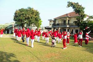 Bogor-Indonesia, August 17, 2023. photo of women doing gymnastics wearing red and white uniforms in field in celebration of Indonesia's Independence Day on August 17