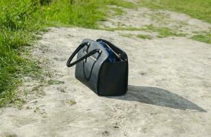 Woman handbag standing on the ground photo