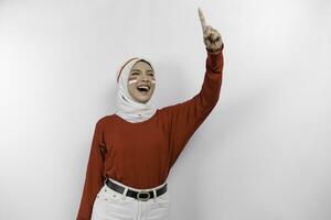 Young woman speaker wearing red top and white hijab gesturing oration with hands isolated on white background. Indonesia's independence day concept. photo