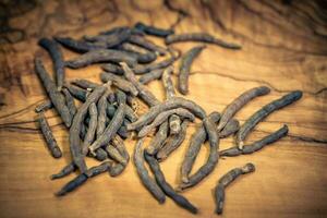 Black long pepper xylopia aethiopica on olive wood photo