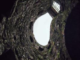 Stone well hole, old construction from inside, fall down in the well photo