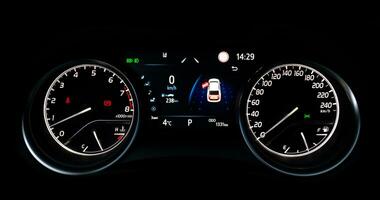 Car speedometer and sensors on a control panel background, car elements close view photo