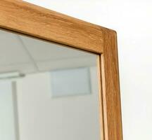 Wooden mirror frame corner isolated over white background, wooden eco furniture elements. Solid wood furniture leg photo