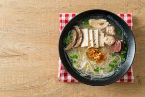 Vietnamese Rice Noodles Soup with Vietnamese Sausage served vegetables and crispy onion photo