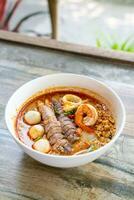 spicy seafood noodles bowl in Thai style photo