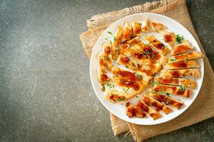 grilled chicken breast sliced on plate photo