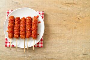 fried sausage skewer with ketchup photo