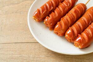 fried sausage skewer on plate photo