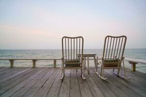 empty chair on balcony with sea background photo