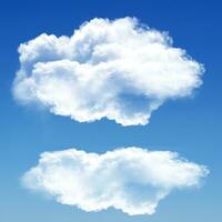 Two white clouds isolated over blue background photo