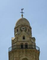 Clock tower with a weathercock photo