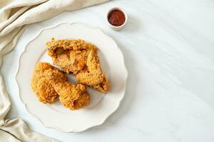 fried chicken with ketchup on plate photo