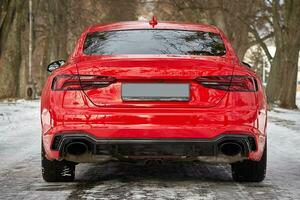 Modern red sport car in the winter forest background,  car wallpaper photo