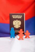 Russian Federation pass. Wooden figures on Russian flag. photo