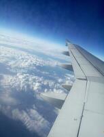 Airplane flight in deep blue sky photo