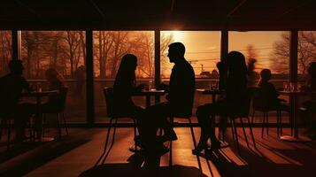 Unidentified individuals dining in a eatery. silhouette concept photo