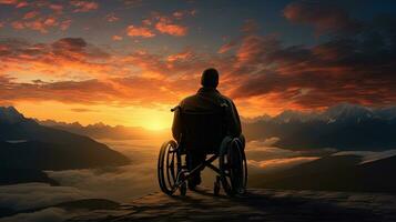 Wheelchair user enjoying sunset on scenic mountain. silhouette concept photo