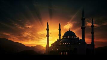 Mosque silhouetted at sundown photo